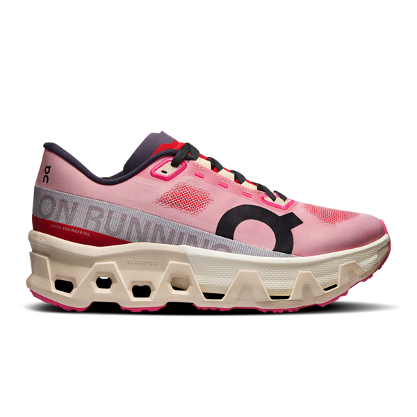 Pink and red running shoe with a unique sole design on a white background.