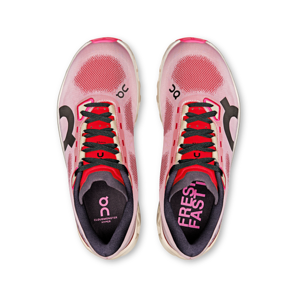 Top view of a pair of pink and red athletic shoes with black laces on a white background.