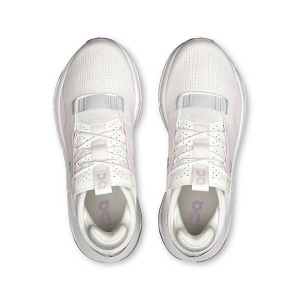 Pair of white athletic shoes with a brand logo on a white background.