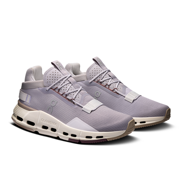 Pair of On gray athletic shoes with white sole on a white background.