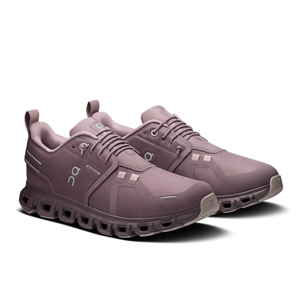 Pair of purple running shoes on a white background
