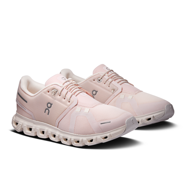 Pair of women's pink running shoes on a white background