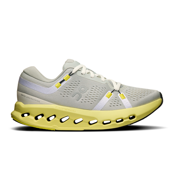 A pair of women's athletic shoes with a gray upper and yellow accents, featuring a lightweight design with visible cushioning units.