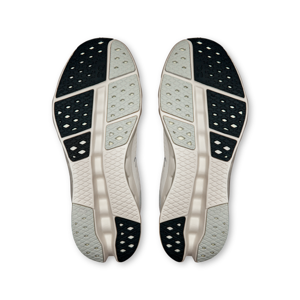 The outsole of these On running shoes are white, grey and black.