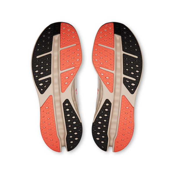 Pair of shoe outsoles with red and black sole design on a white background.