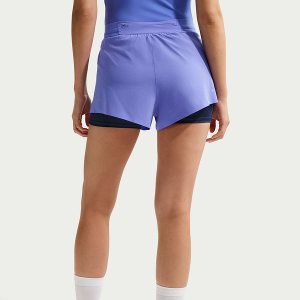 Person wearing a purple athletic skirt on a white background