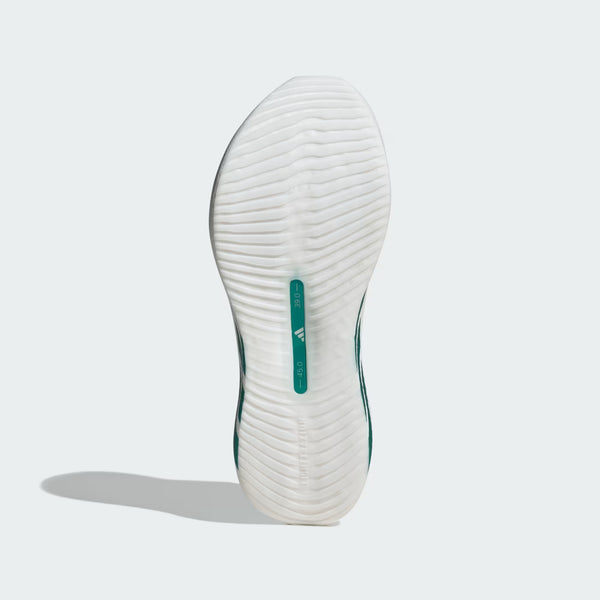 White sneaker sole with green accent on a light gray background