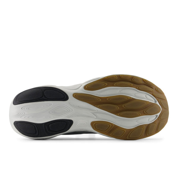 Close-up of a shoe sole with white, black, and brown colors on a white background.