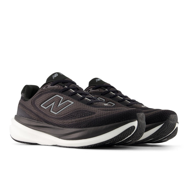 Pair of black and white New Balance running shoes with white soles on a light gray background.