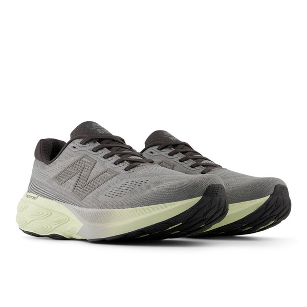 A pair of NB running shoes with black laces and an off white midsole.