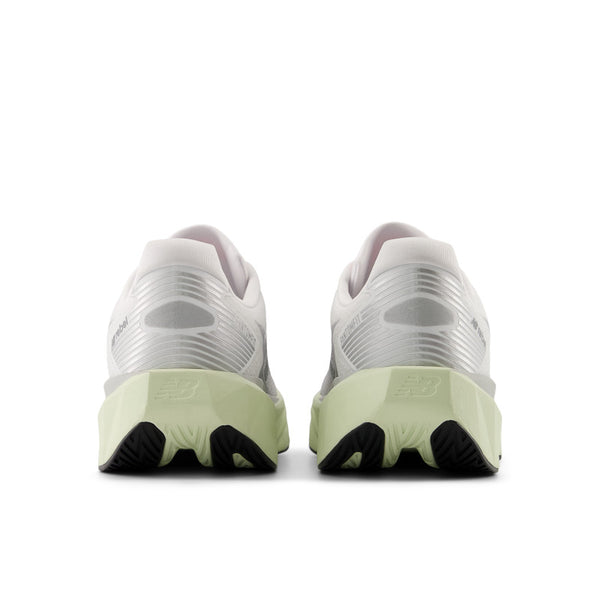 White running shoes with green midsole on a white background where the black outsole just barely comes through.