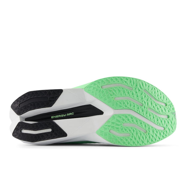 Close-up of a running shoe with green sole and black and white accents on a white background