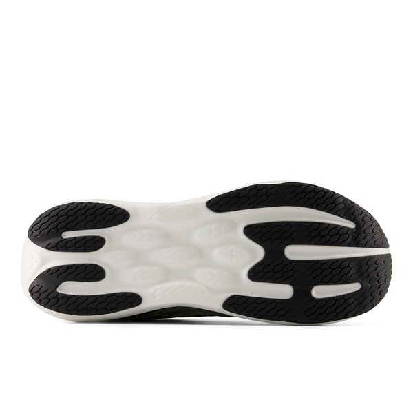 Green running shoe with white sole on a white background