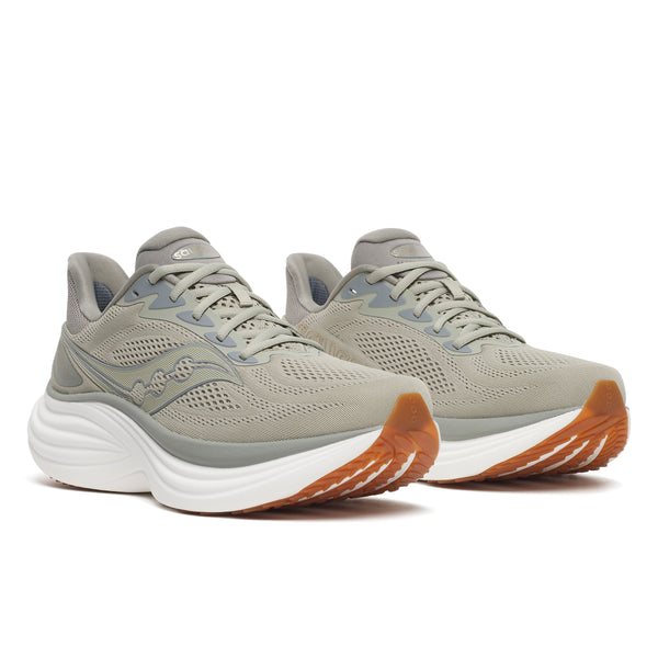 Pair of gray running shoes with orange soles on a white background