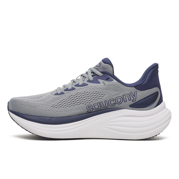 The medial side of a gray and blue running shoe with 'Saucony' branding on a white background