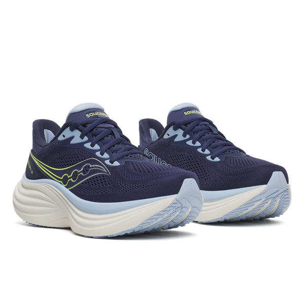 Navy running shoes with white soles on a white background