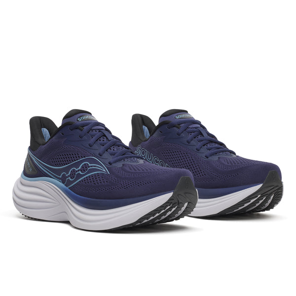 Pair of blue running shoes with white soles on a white background
