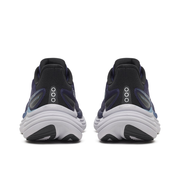 The heel of this mostly navy shoe has a black and white colorway with the 3 dot Saucony logo.