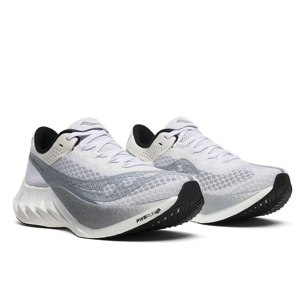 White, silver and grey Saucony women's running shoes with black soles on a white background.