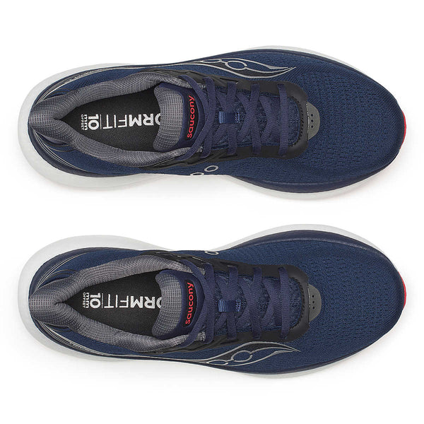 Navy running shoes with white soles on a white background.