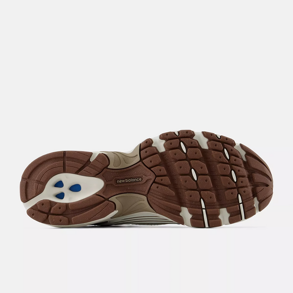 A New Balance athletic sneaker in beige, white, and brown, shown against a plain white background.