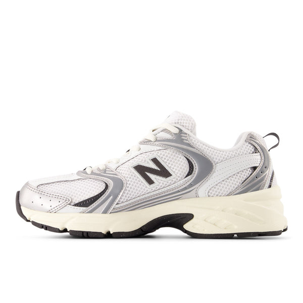 Medial side of a white and gray 530 sneaker with New Balance logo on a white background