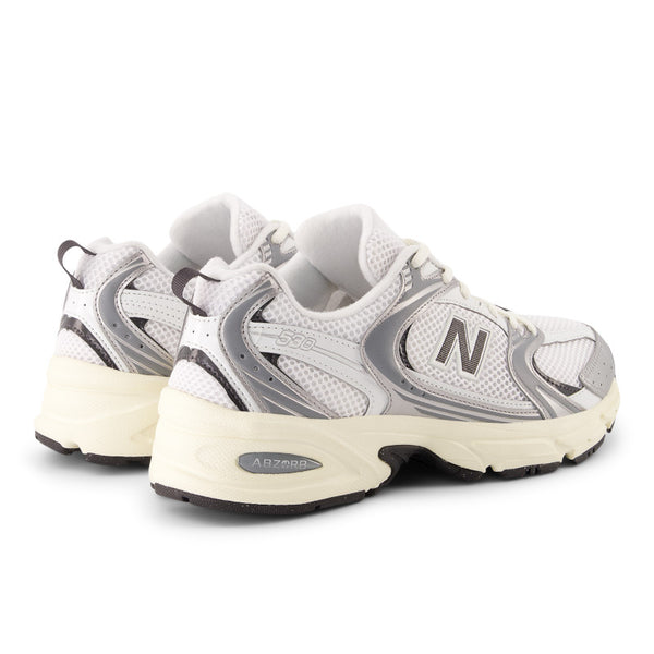 White and gray sneakers with New Balance logo on a white background