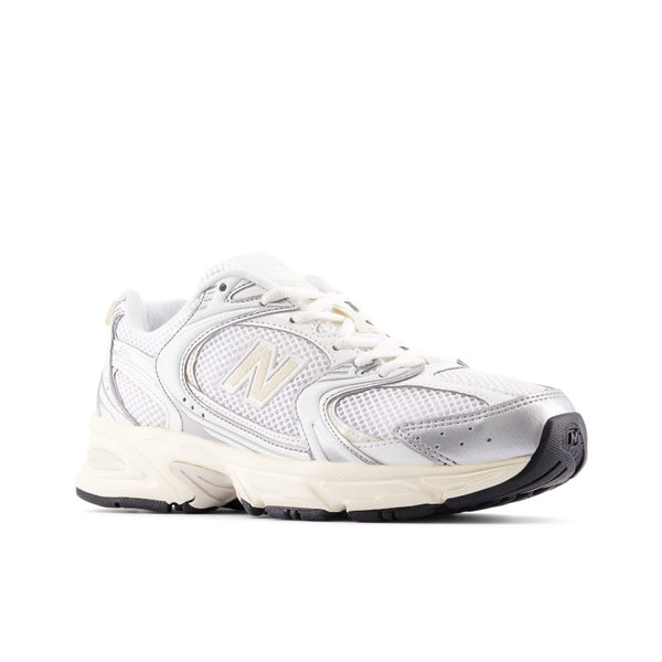 White sneaker with black sole on a white background