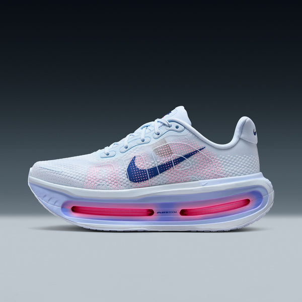 White Nike Vomero Premium running shoe with pink and blue accents on a gray background.