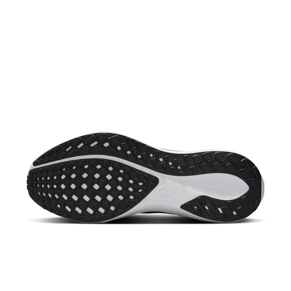 The outsole of this Nike running shoe is all black where the rubber is and the white midsole comews through in a few places.