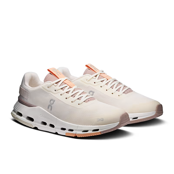A pair of On Cloudrunning sneakers in a light cream/off-white colorway with peach and light pink accents, shown on a clean white background.