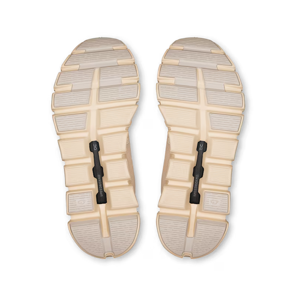 Pair of beige and gray shoe soles on a white background