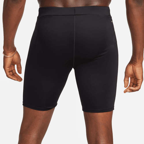 Black athletic shorts worn by a person on a plain background