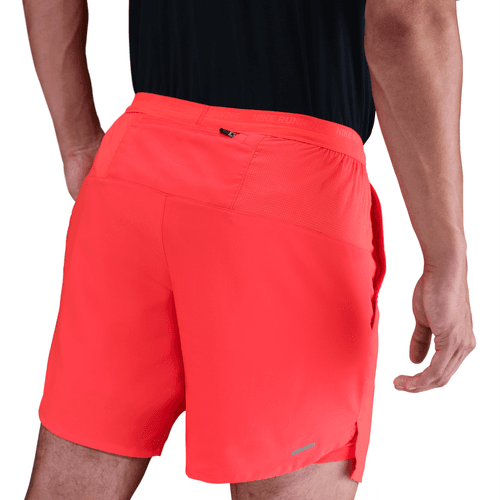 Red shorts worn by a person on a white background