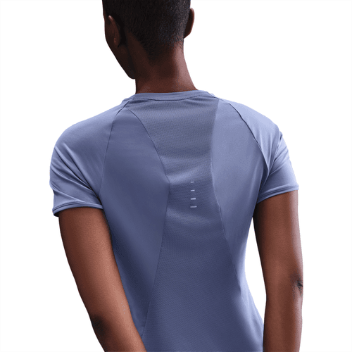 Person wearing a light blue athletic shirt with a focus on the back design.