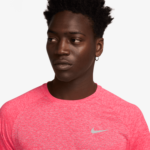 Person wearing a bright red Nike shirt against a white background