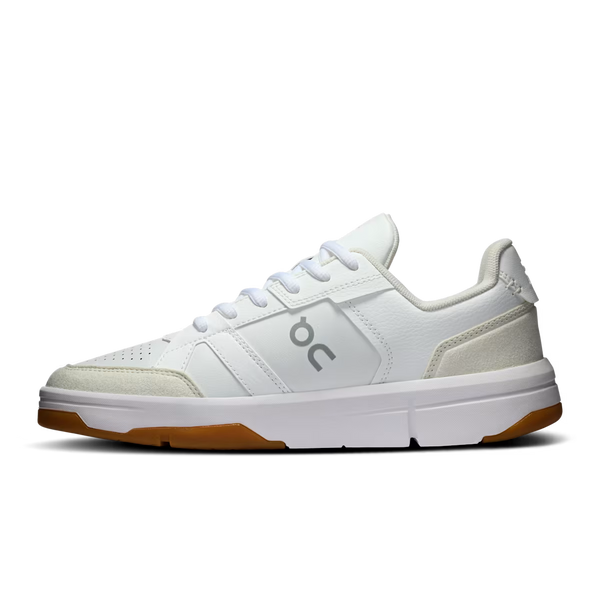 White sneaker with brown sole on a white background