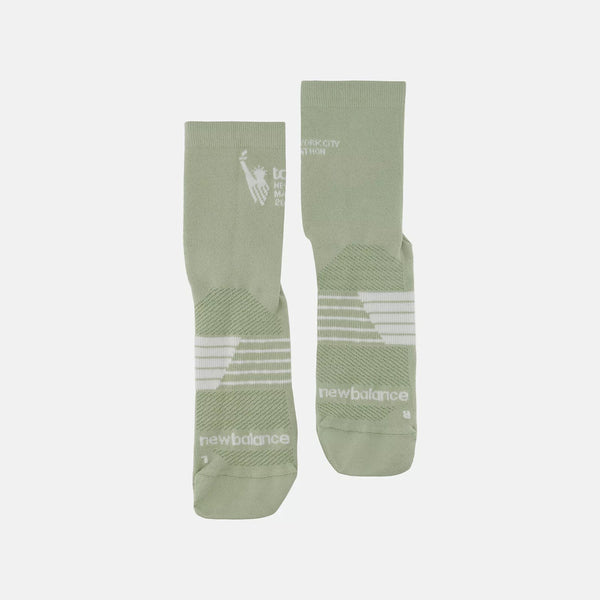 Two green socks with white branding on a light gray background