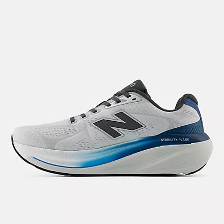 A New Balance running shoe in white, gray, and blue against a light gray background.