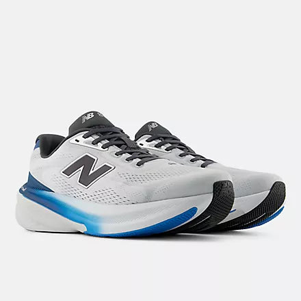 A New Balance running shoe in white, gray, and blue against a light gray background.