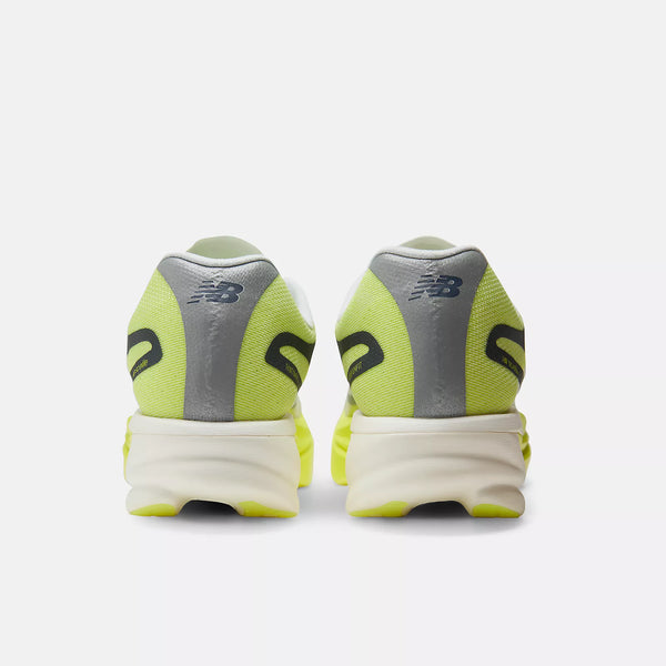 A pair of New Balance sneakers shown from the back, featuring a neon yellow-green mesh upper, gray synthetic overlays, and a thick white midsole.