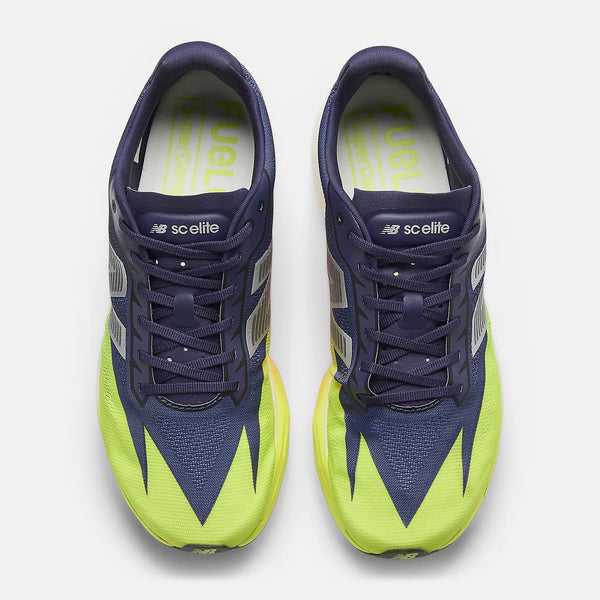 Navy and green running shoes with 'sclelite' branding on a white background