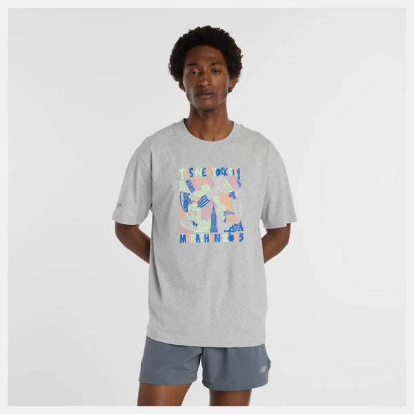 Person wearing a gray t-shirt with colorful graphic design on a white background