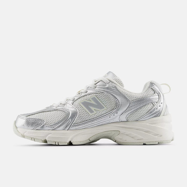 Silver sneaker with New Balance logo on a white background