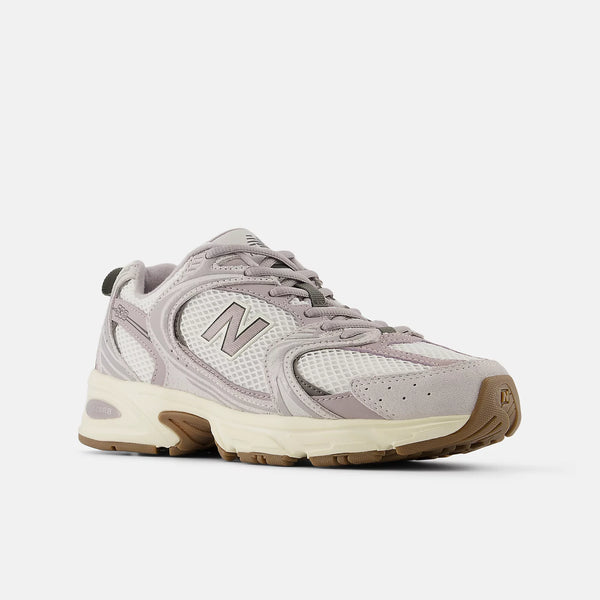 Gray sneaker with brown sole on a white background
