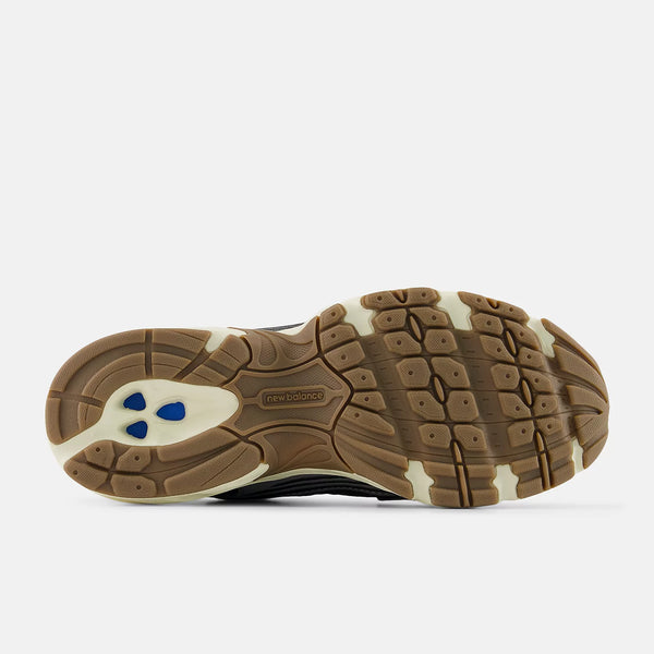 Brown and beige sole of a shoe with brand logo on a white background