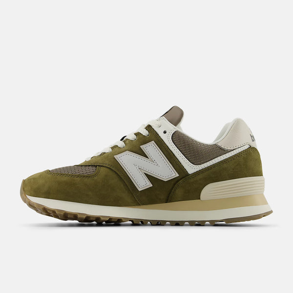 Green sneaker with white sole on a light gray background