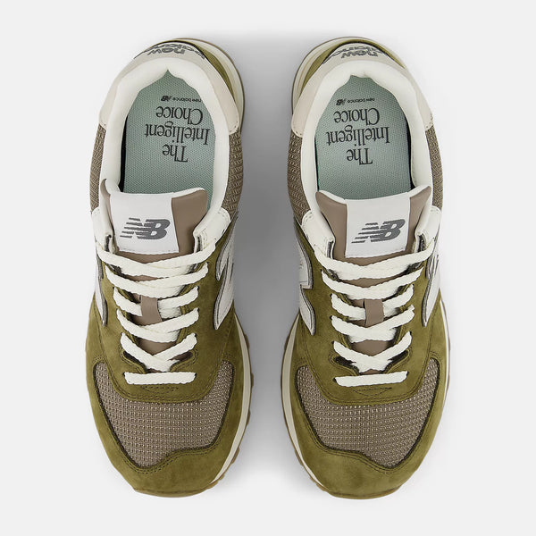 Pair of green sneakers with white laces on a white background