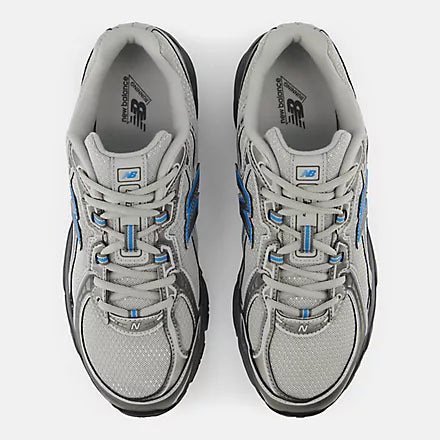 A New Balance athletic shoe in gray and black with a blue 'N' logo on the side, shown against a light gray background.