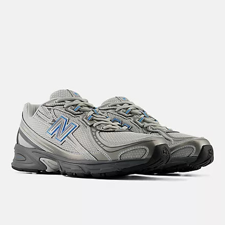 A New Balance athletic shoe in gray and black with a blue 'N' logo on the side, shown against a light gray background.